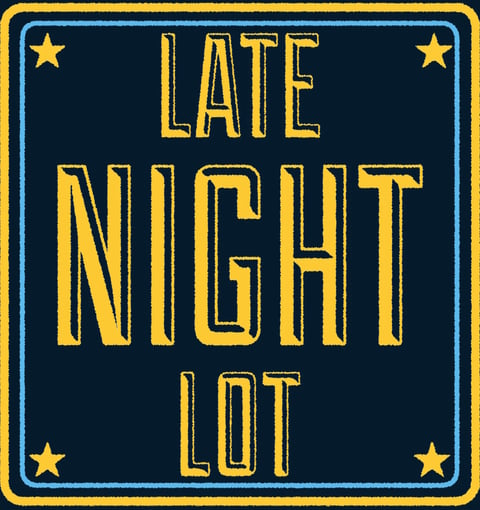 Yellow and blue rectangular sign reading Late Night Lot with four gold stars in corners