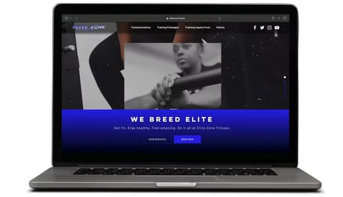 Laptop displaying dark-themed website with WE BREED ELITE banner